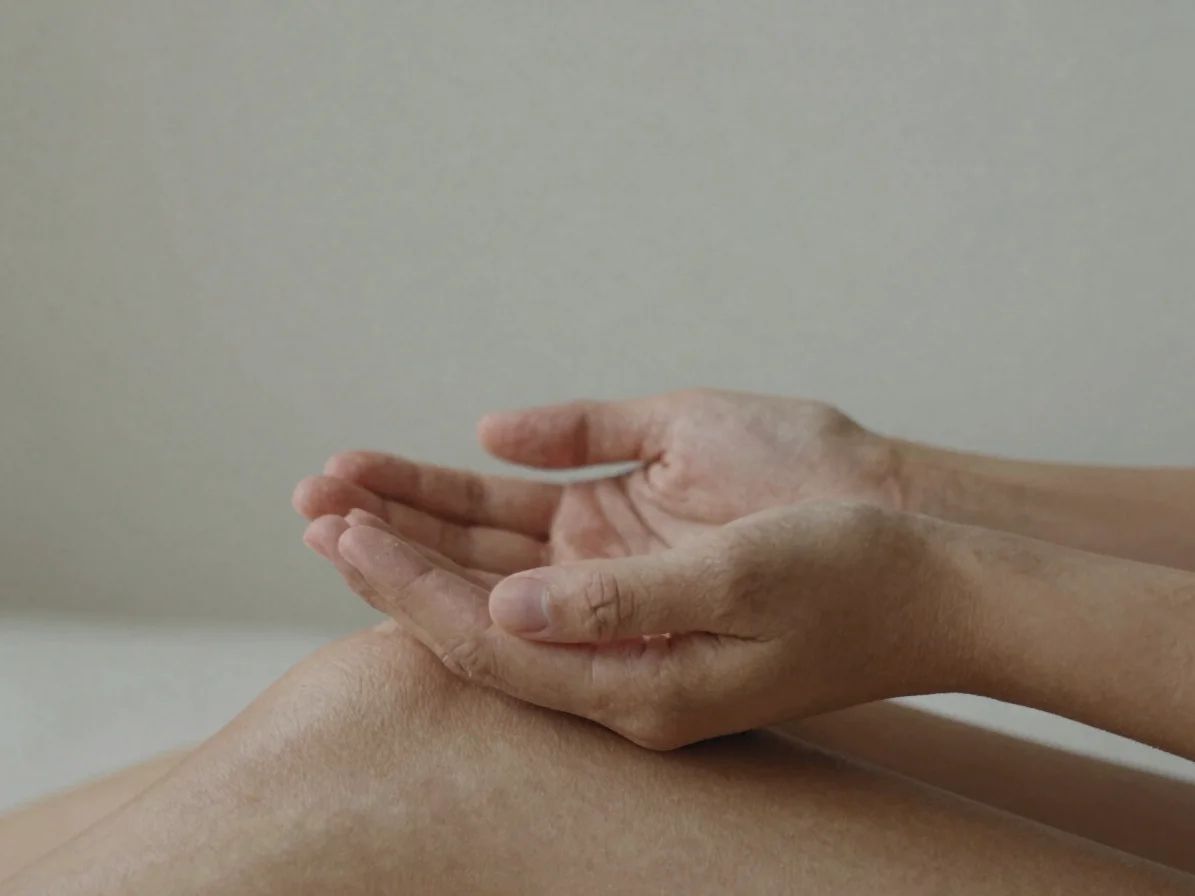 Intimate close-up of hands loosely cupped in the lap during a slo